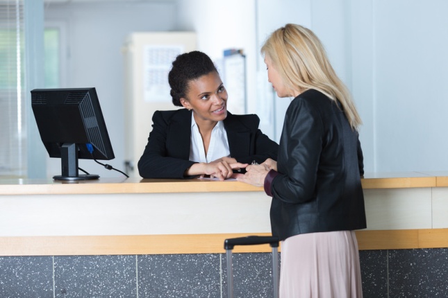 hotel receptionist doing check-in for a customer